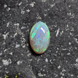 Opal stone on a dark textured background