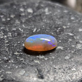 Opal stone on a dark stone surface
