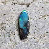 Opal stone on a textured beige surface