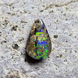 Opal stone on a textured gray surface