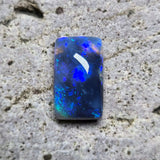 Blue opal stone on a textured beige surface