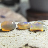 Three translucent gemstones on a textured surface