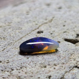 Opal stone on a textured stone surface