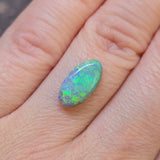 Opal stone on a person's finger