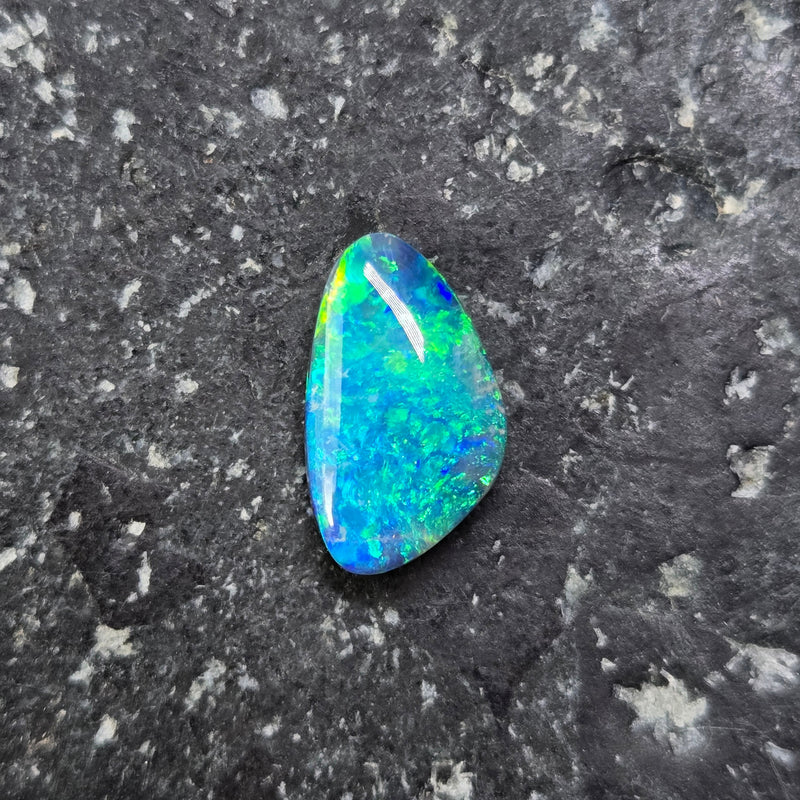 Opal stone on a dark, textured surface
