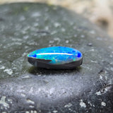 Blue opal stone on a dark stone surface