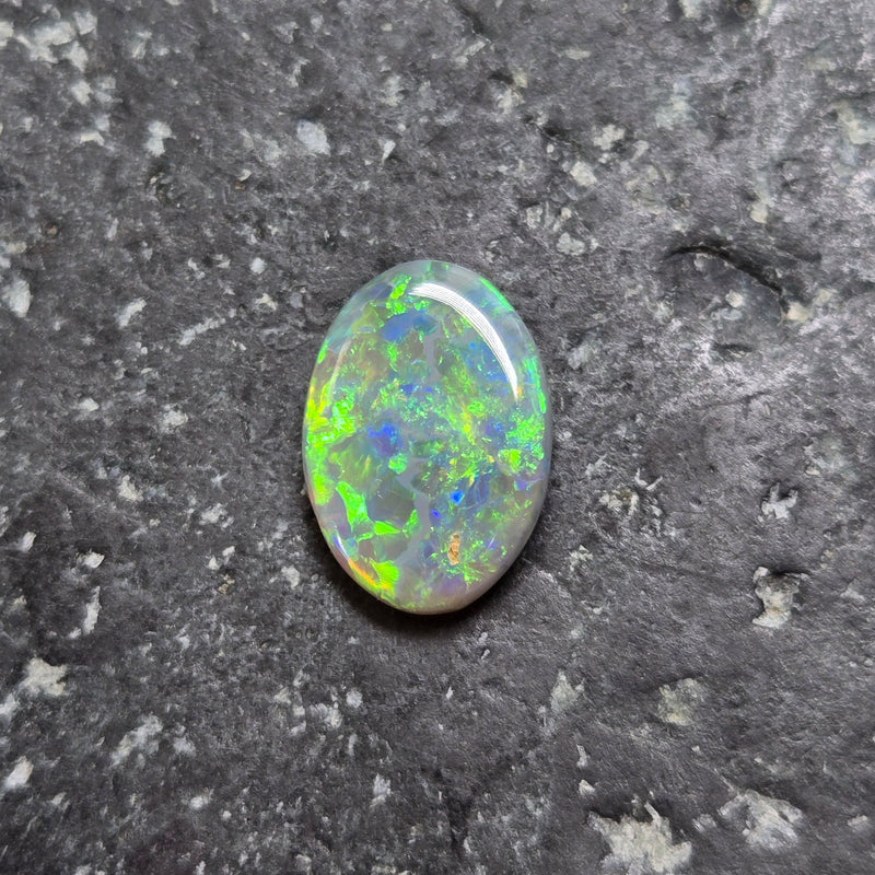Opal stone on a dark, textured surface