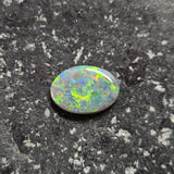 Opal stone on a textured dark surface