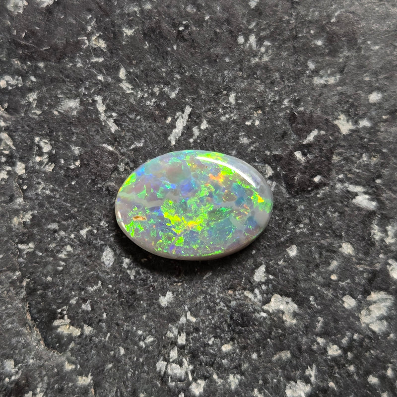 Opal stone on a textured dark surface
