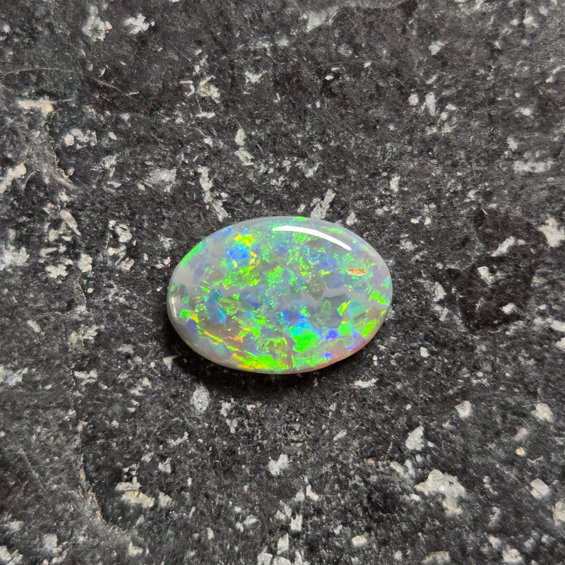 Opal stone on a dark, textured surface