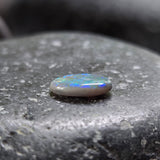 Opal stone on a dark stone surface