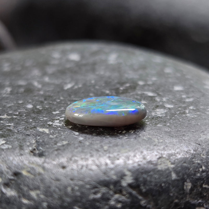 Opal stone on a dark stone surface