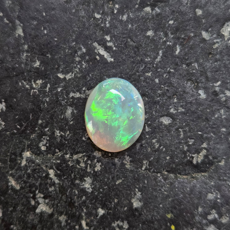 Opal stone on a dark, textured surface