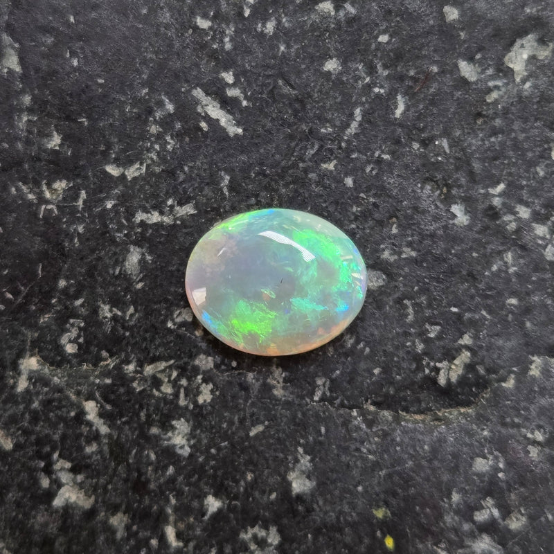 Opal stone on a dark, textured surface