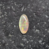 Opal stone on a dark gray surface