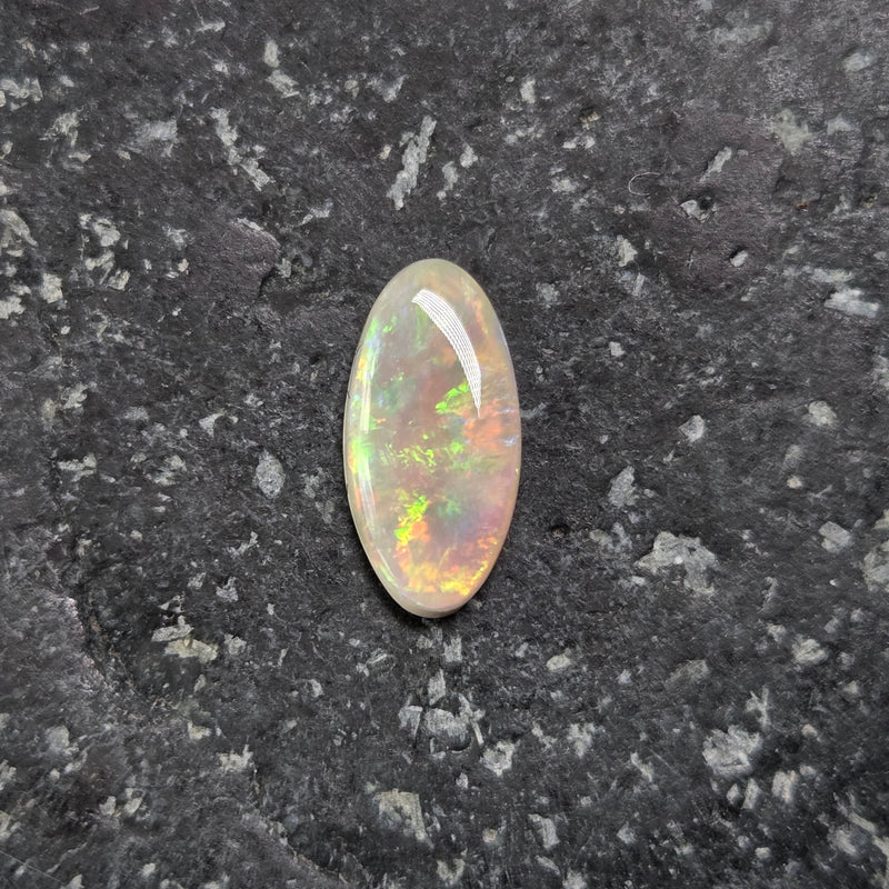 Opal stone on a dark gray surface
