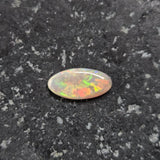 Opal stone on a dark, textured surface