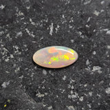 Opal stone on a dark textured surface