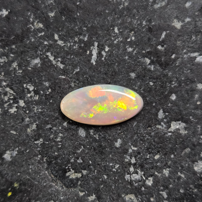 Opal stone on a dark textured surface