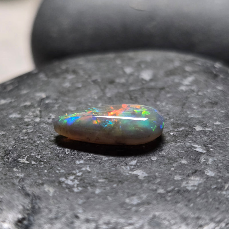 Opal stone on a dark gray surface