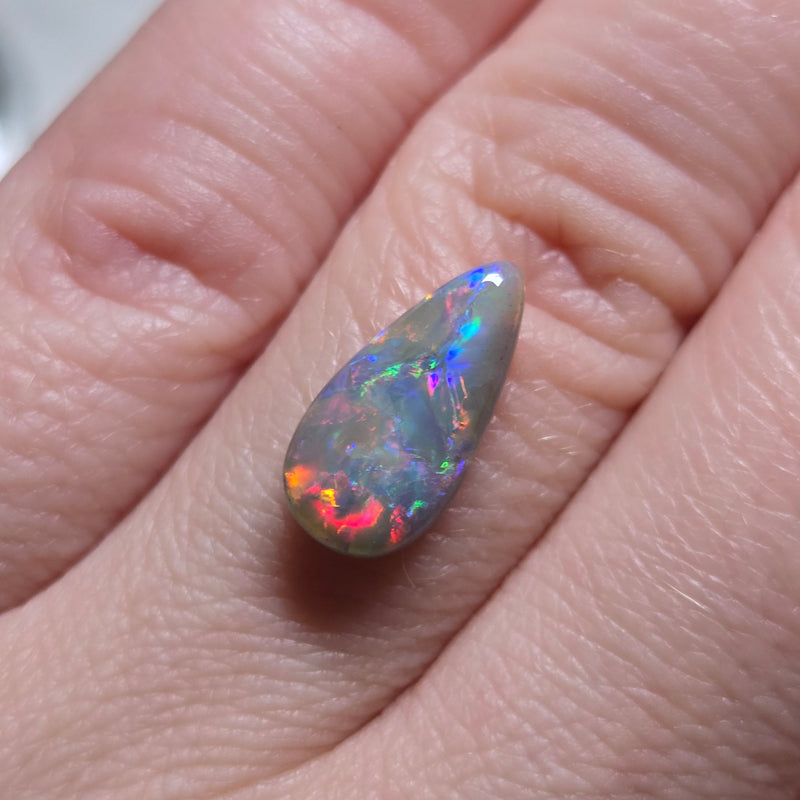 Opal stone held on finger