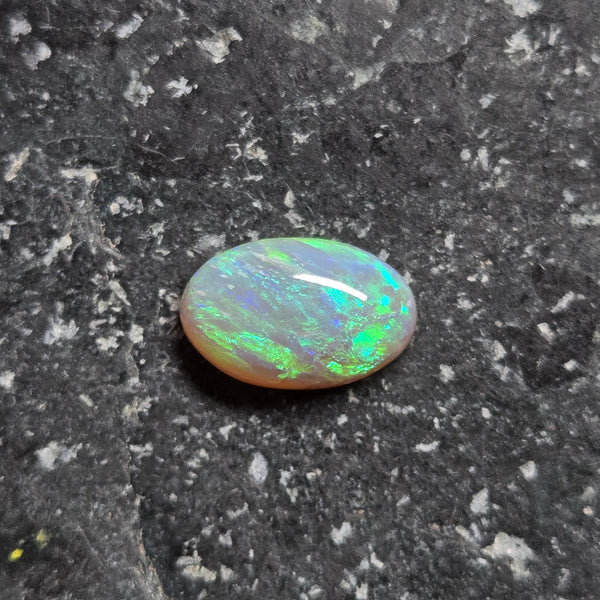 Opal stone on a dark, textured surface