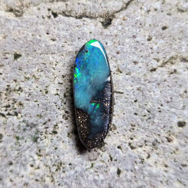 Opal stone on a textured beige surface