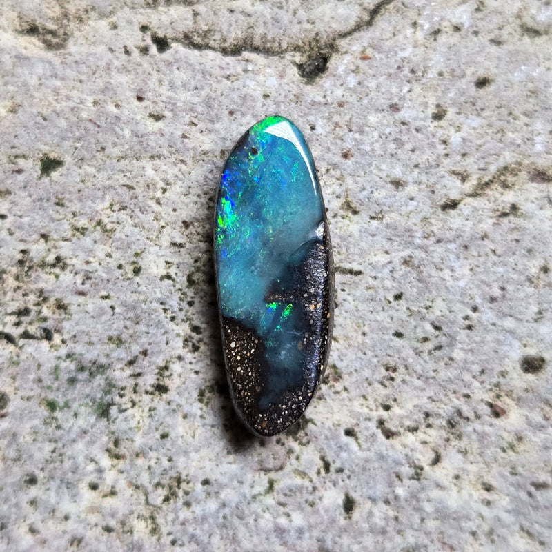 Opal stone on a textured beige surface