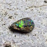 Opal stone on a textured gray surface