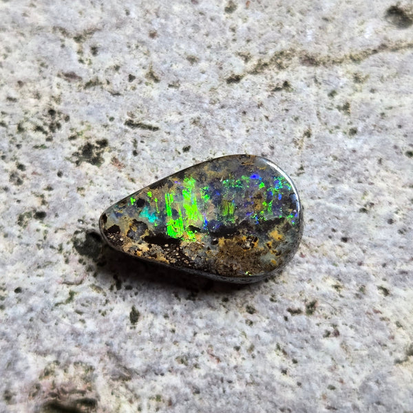 Opal stone on a textured gray surface