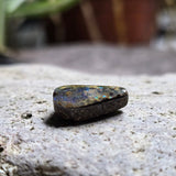 Mineral sample on a textured stone surface