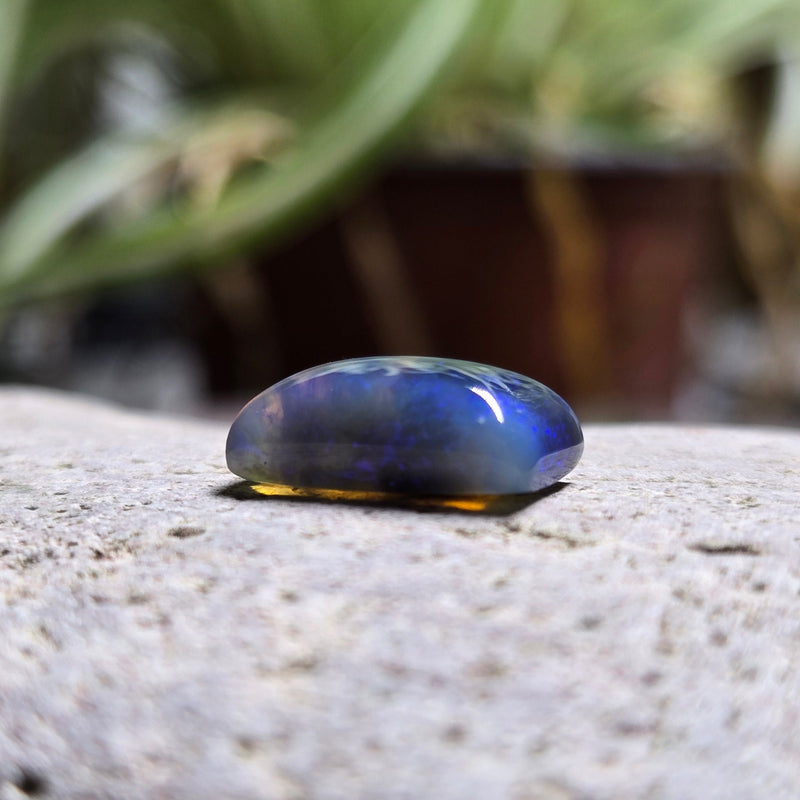 Blue stone on a textured surface with blurred background