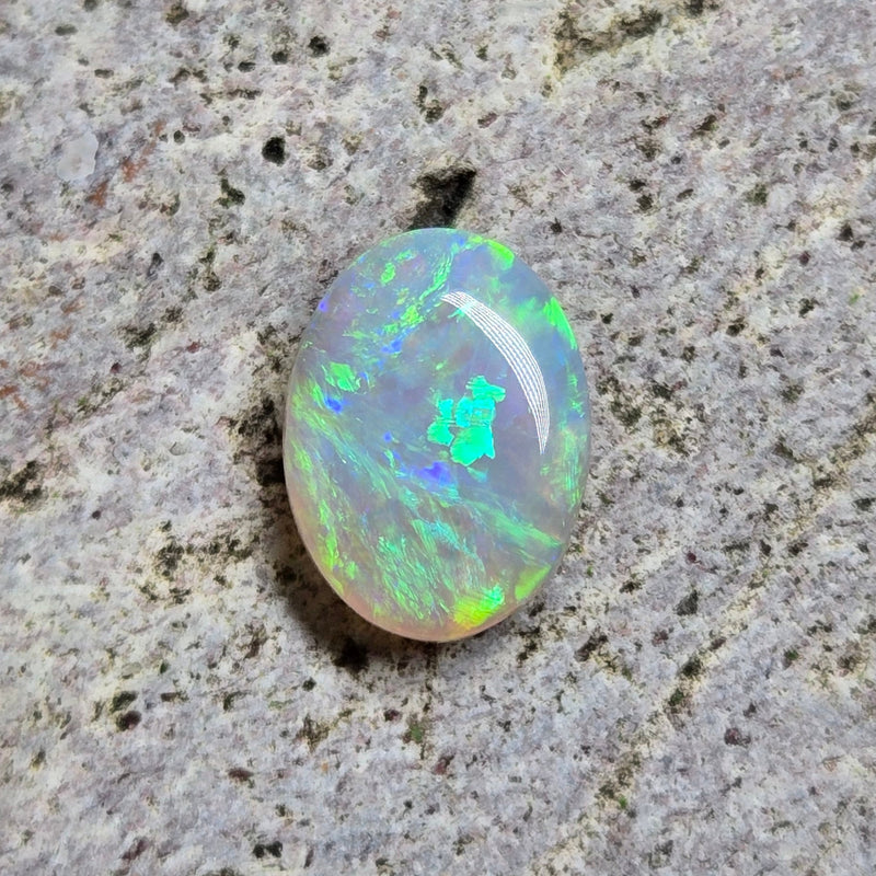 Opal stone on a textured gray surface
