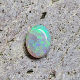 Green opal on light textured stone surface