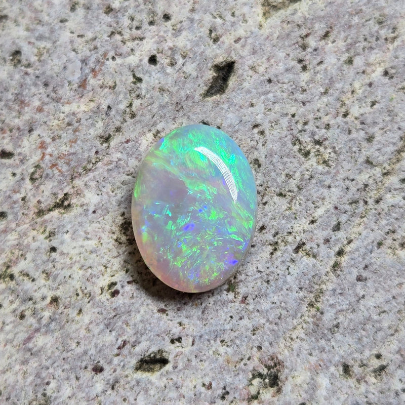 Green opal on light textured stone surface