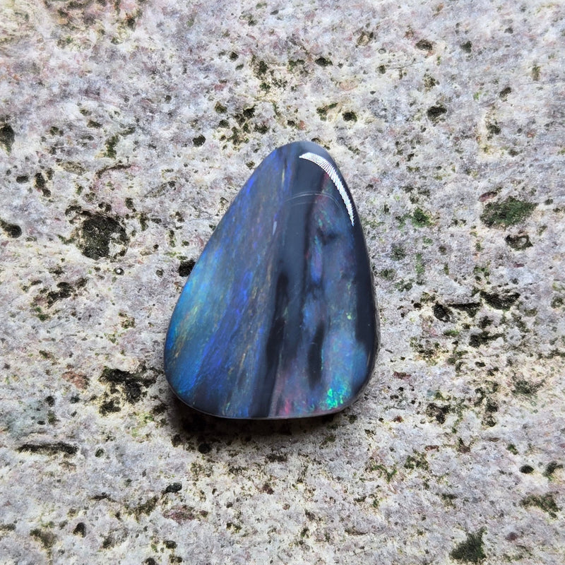 Blue stone on a textured gray surface