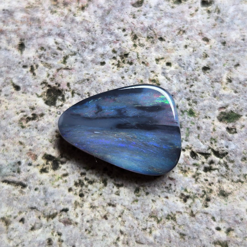 Blue stone on a textured gray surface