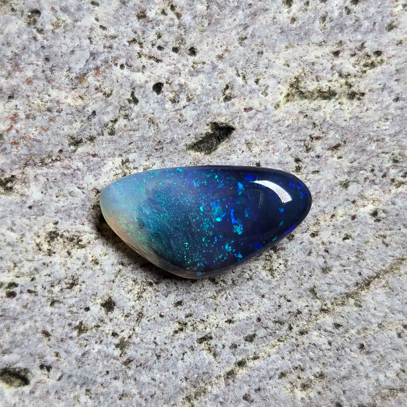 Blue stone on a textured gray surface