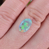 Opal gemstone on a finger