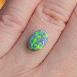 Opal stone on a finger