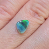 Opal stone on a person's finger