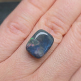 Opal stone held between fingers