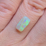 Opal gemstone on a finger